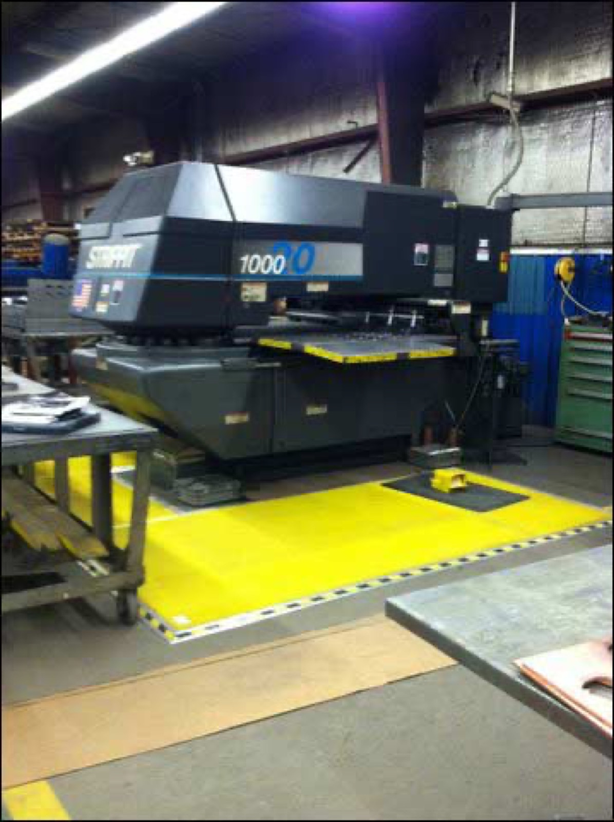 Turret press with bright yellow safety mat